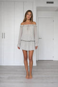 Front view of model wearing grey off-the-shoulder chiffon mini dress