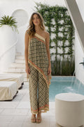 Model wearing green geometric print one-shoulder jumpsuit front view