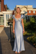 Front view of light blue satin lace trim maxi dress on model outdoors