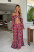 Model wearing burgundy boho off-shoulder crop top and wide leg pants set