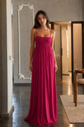 Front view of model wearing fuchsia spaghetti strap maxi dress