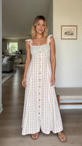 Front full view of woman wearing beige gingham maxi dress