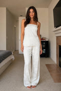 Front view of woman wearing white palm embroidered camisole and wide-leg pants set