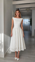 Front full view of woman wearing white boatneck midi dress