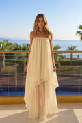 Front view of model wearing cream strapless layered maxi dress