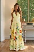 Front view of yellow halter neck floral maxi dress