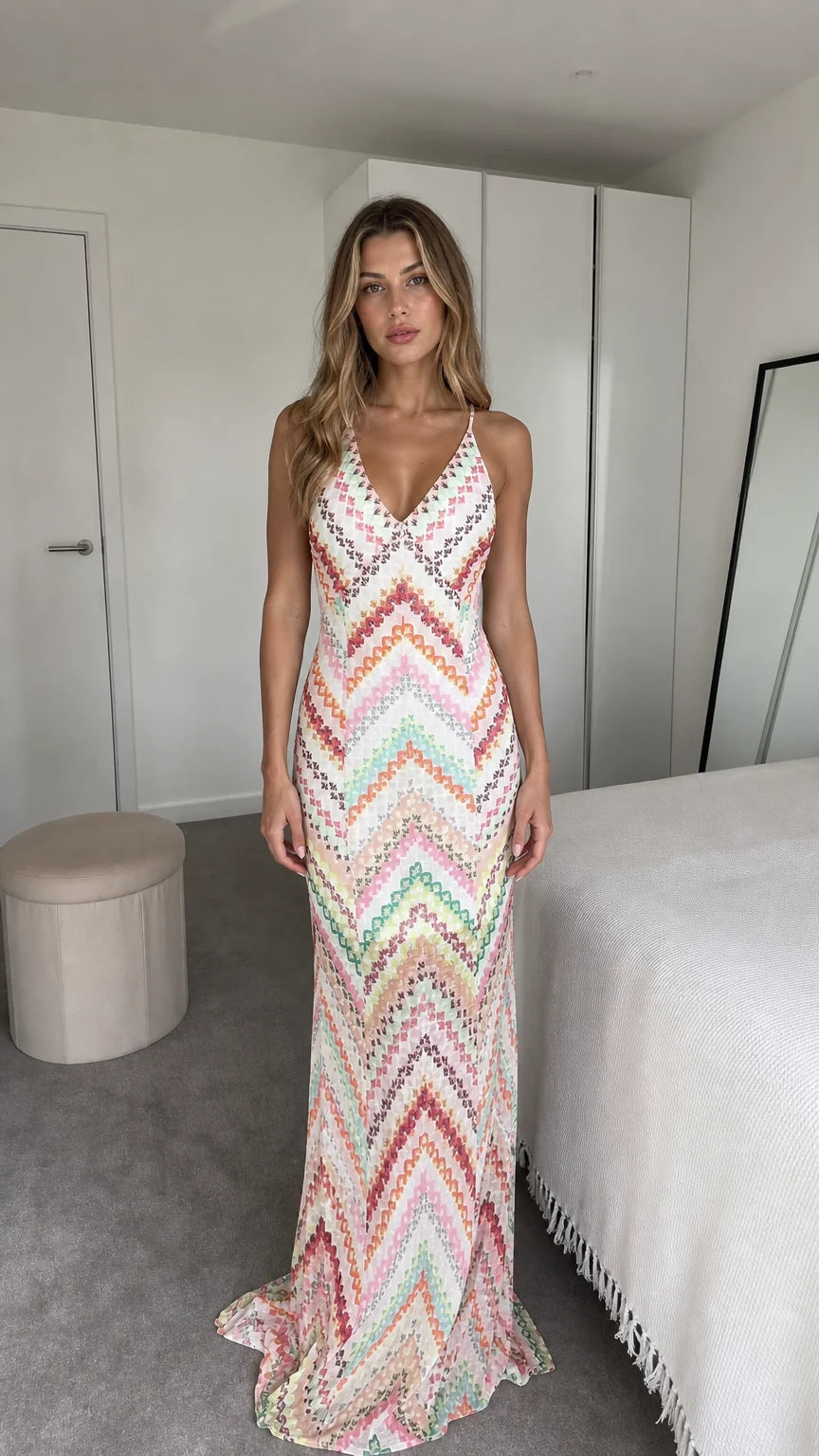 Front view of model wearing white chevron maxi dress