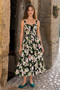 Front full view of black floral midi dress worn by model outdoors