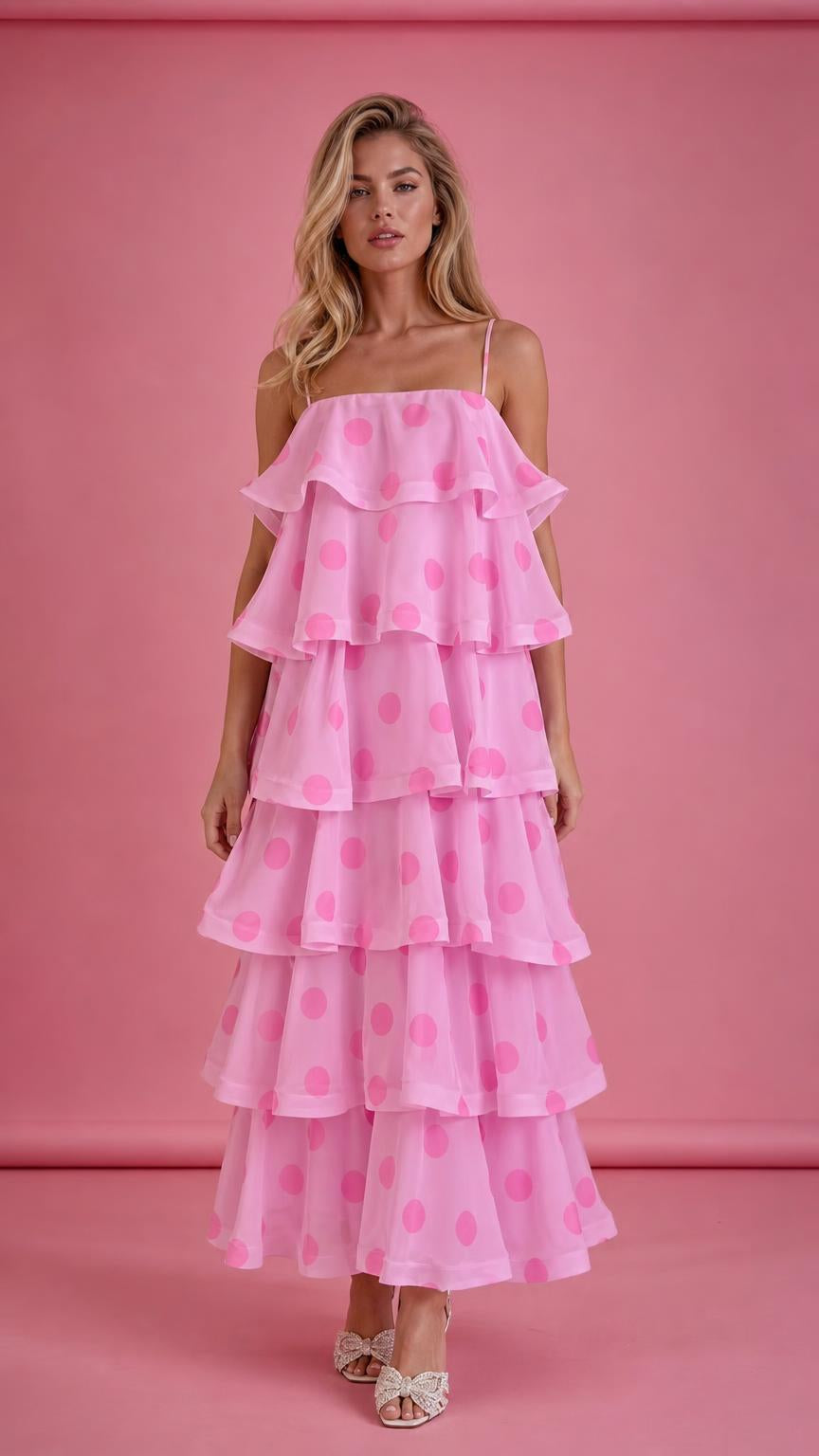 Front view of model wearing pink polka dot tiered ruffle midi dress