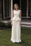 Front view of model wearing white fringed peplum maxi dress outdoors