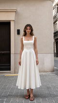 Front view of woman wearing white square neck midi dress