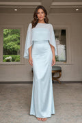 Model wearing light blue cape-overlay evening gown from the front