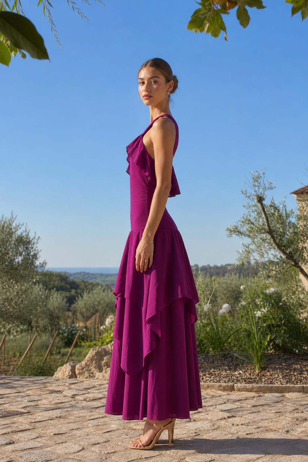 Side profile view of fuchsia maxi dress in outdoor setting
