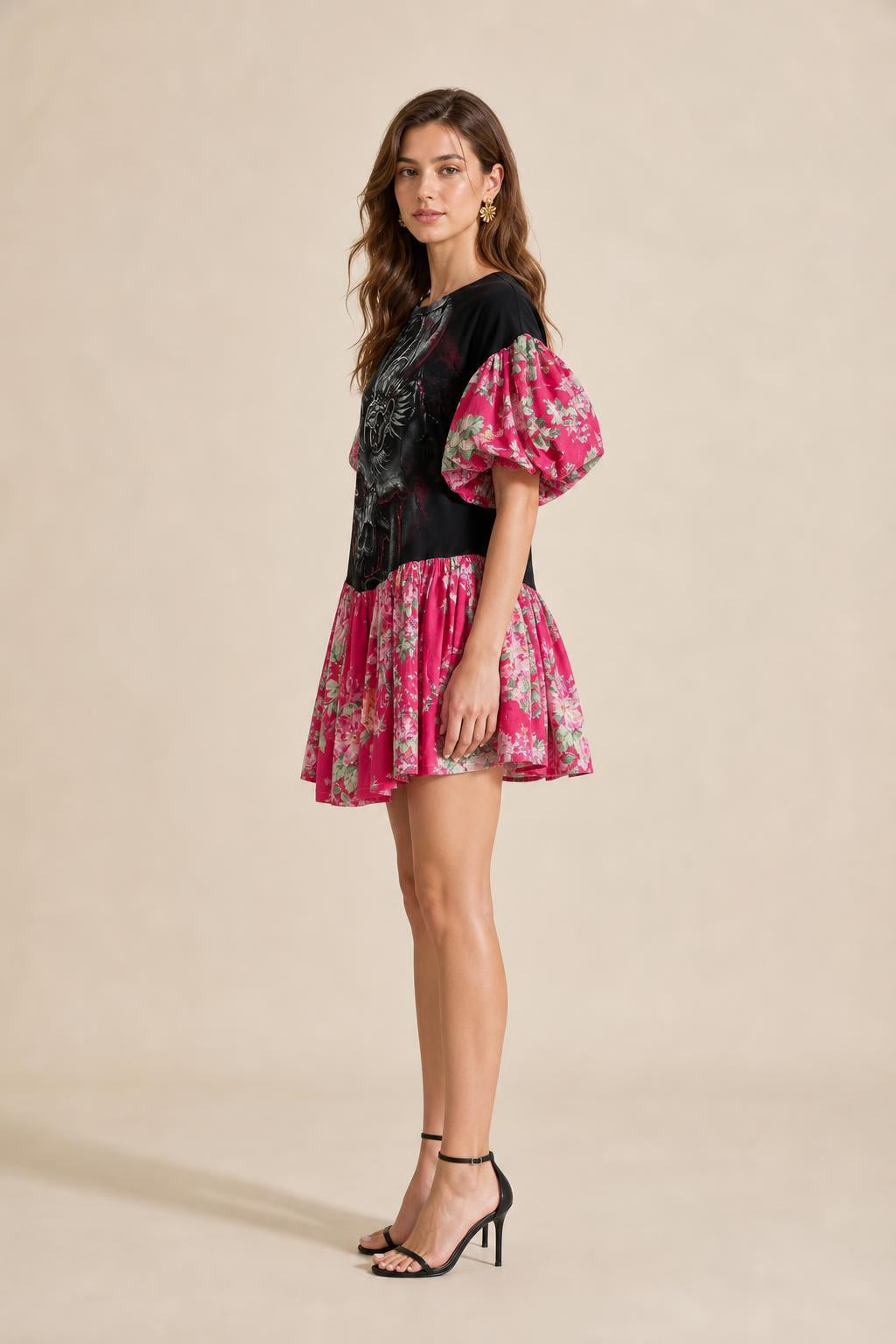 Side profile view of model in black graphic mini dress