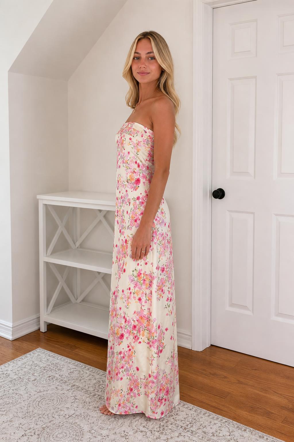 Side view of model in ivory floral strapless maxi dress