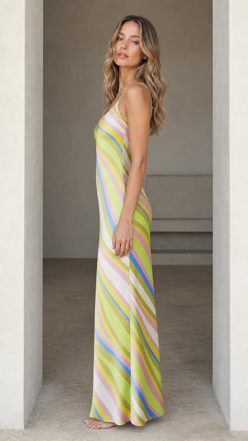 Side profile of woman wearing Lime Multi striped maxi slip dress