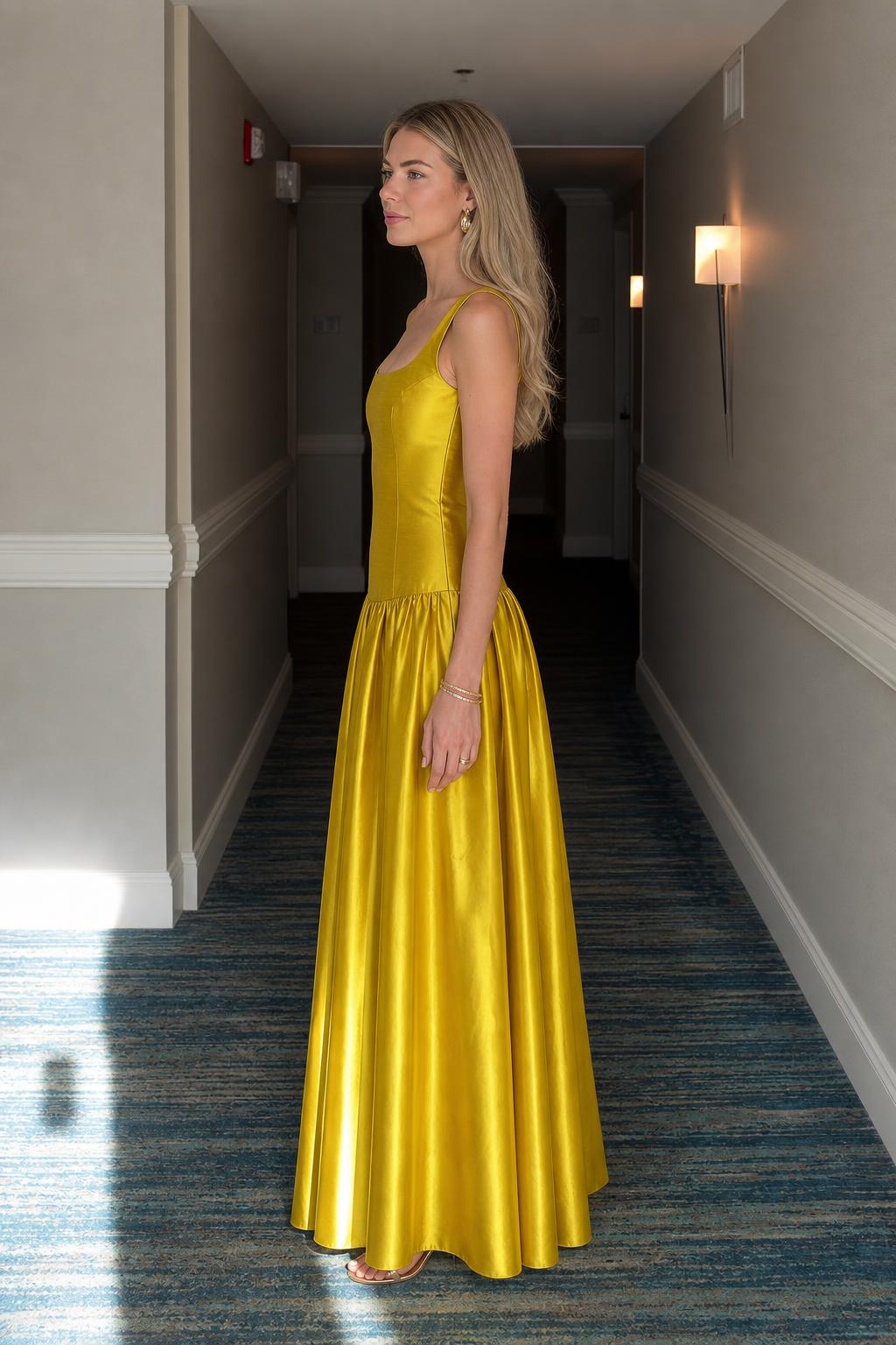 Side profile view of yellow satin maxi dress
