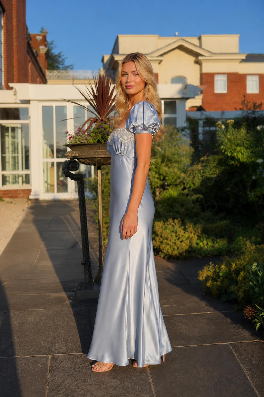 Side profile view of light blue satin maxi dress