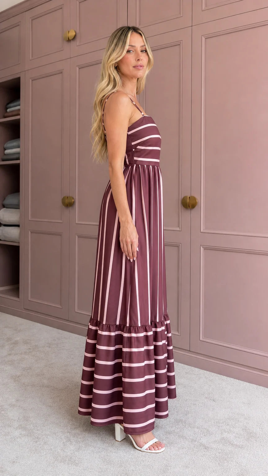 Woman wearing burgundy striped maxi dress side view