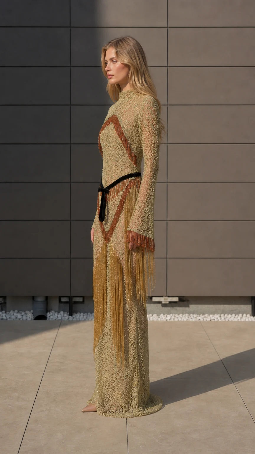 Side profile of model in gold fringe maxi dress