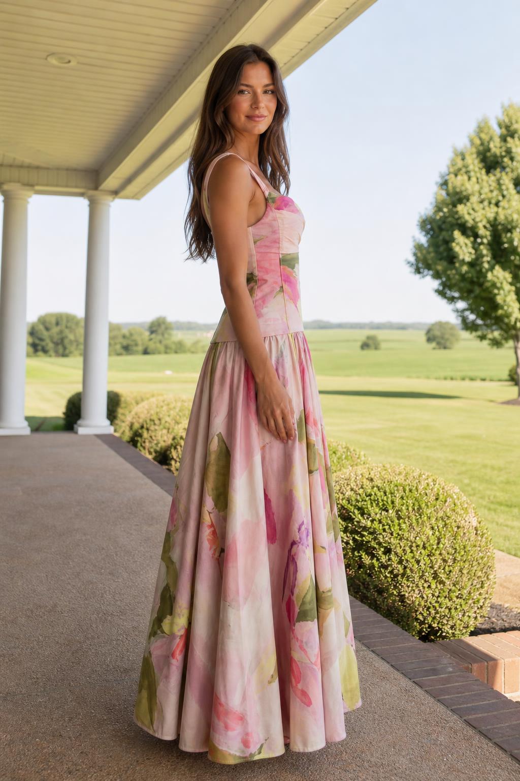 Side profile view of model in pink floral maxi dress outdoors