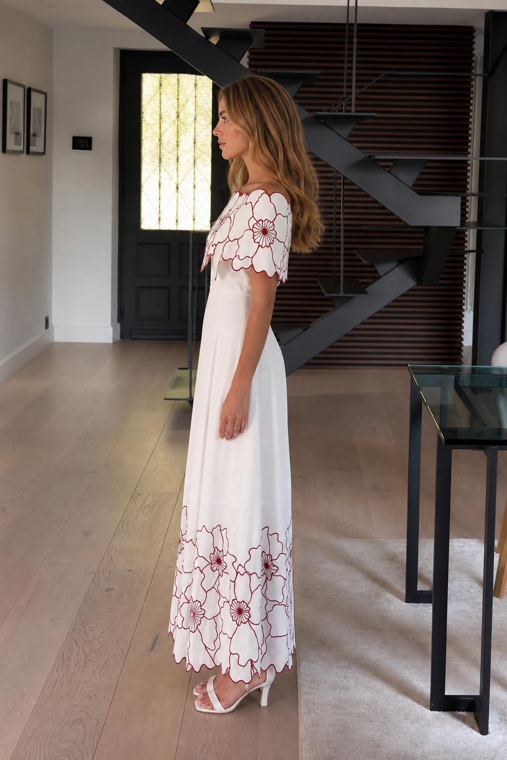 Side profile view of white floral embroidered maxi dress