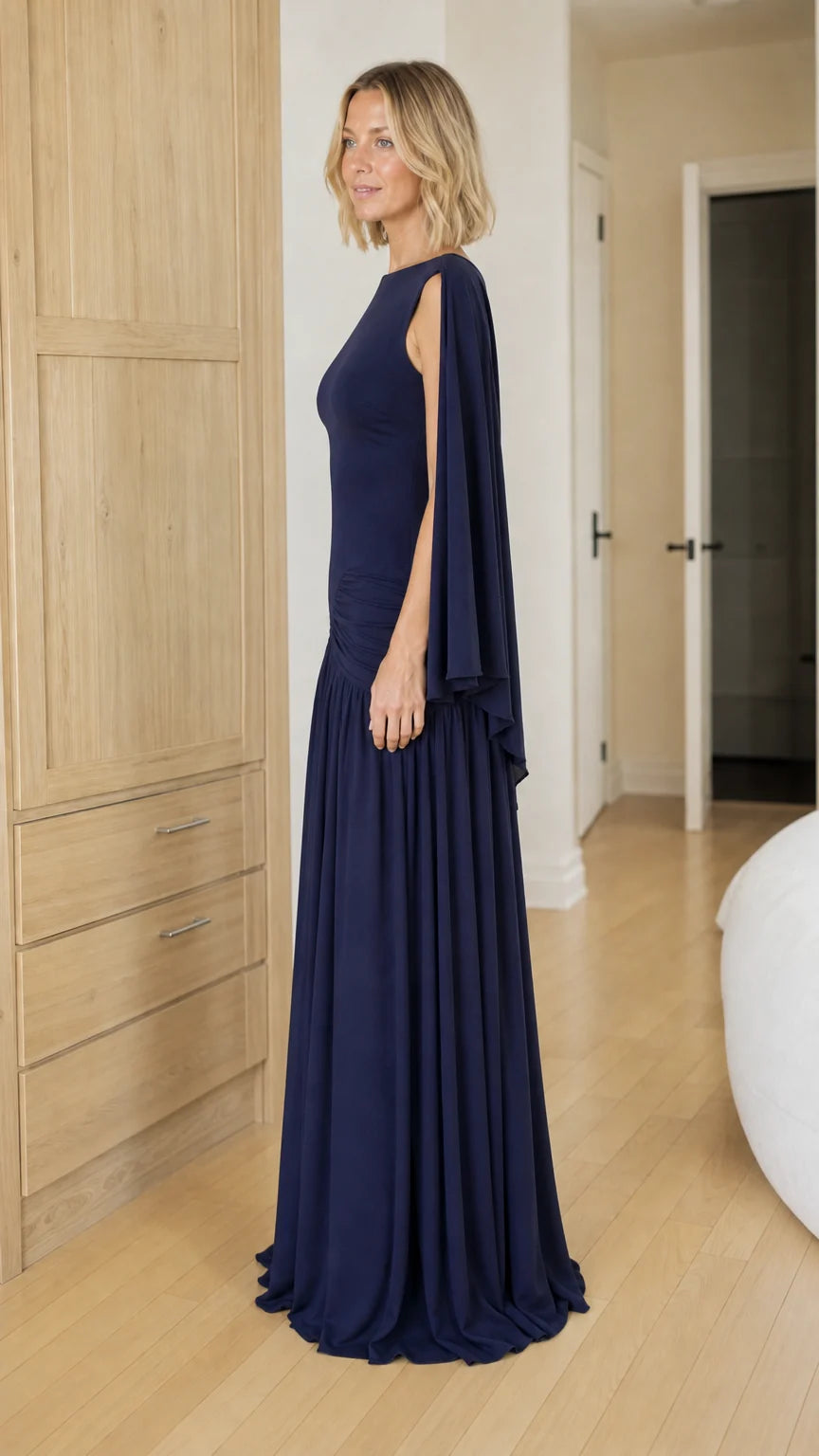 Side profile view of navy blue evening gown with draping sleeves