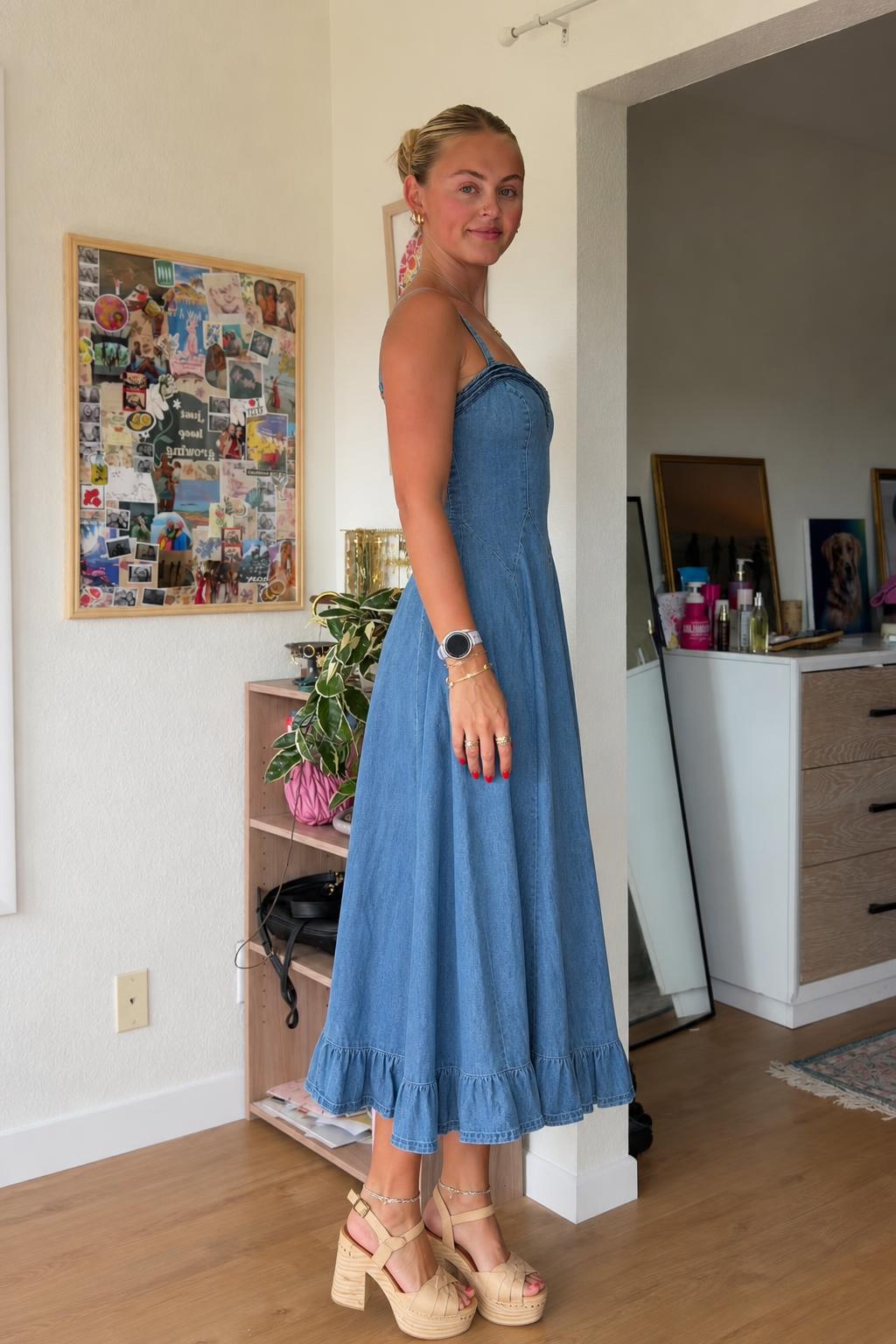 Side profile view of blue denim midi dress