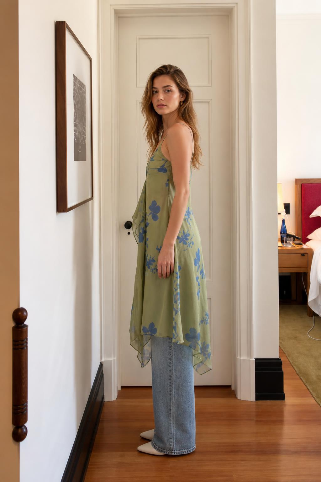 Side view of model in sage green floral cami dress