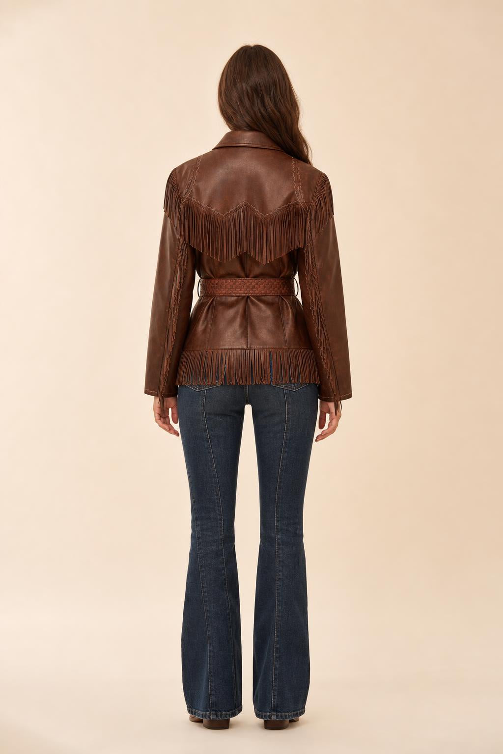 Back view of woman showing fringe details on the back of the brown jacket