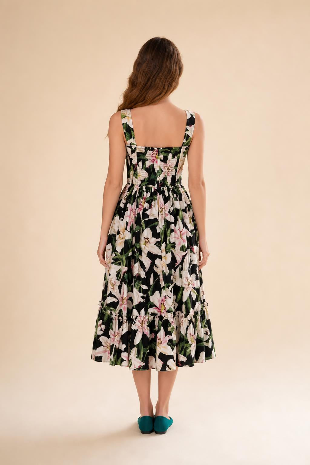 Back view of black floral midi dress against neutral background