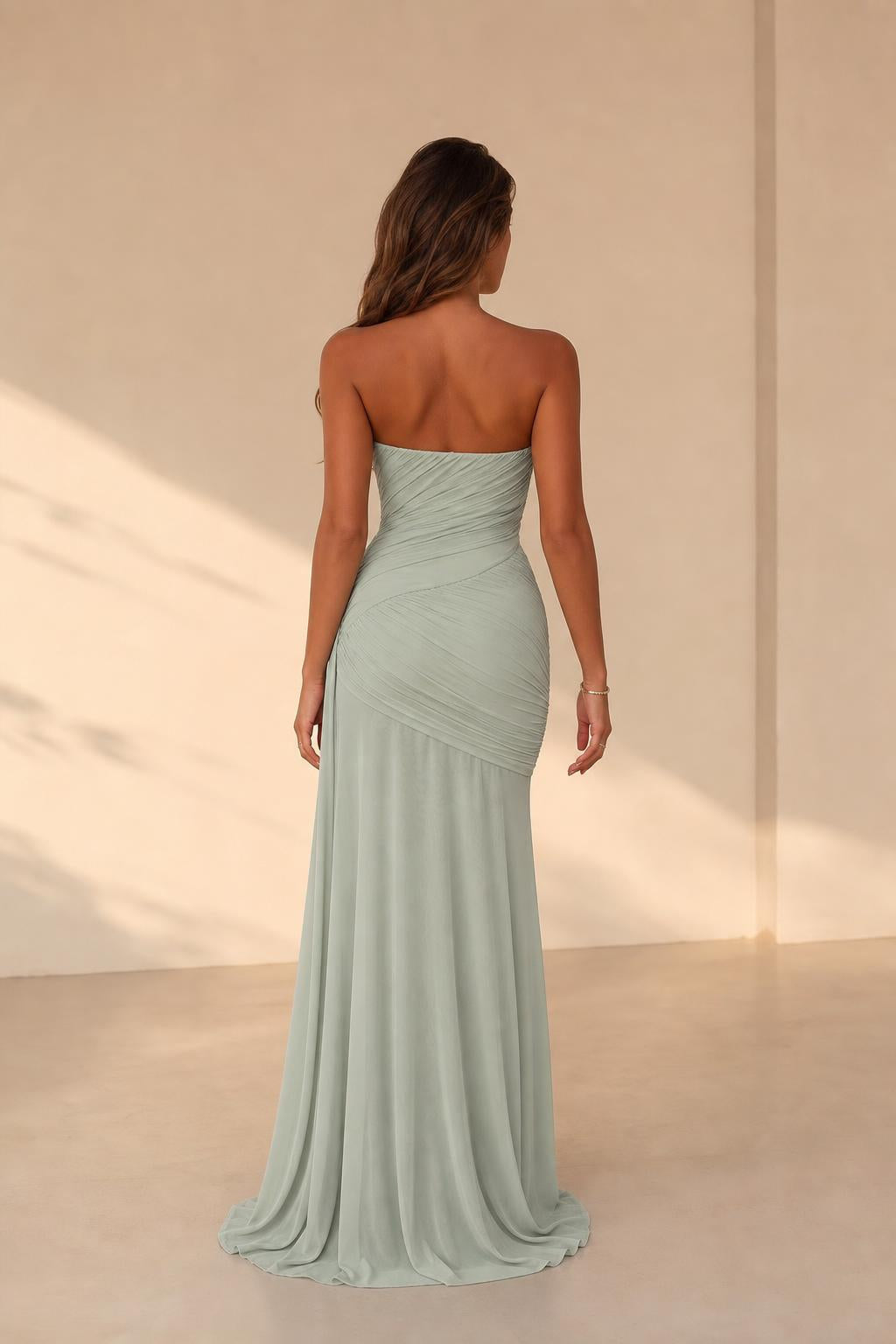 Model wearing sage green ruched maxi dress, back view