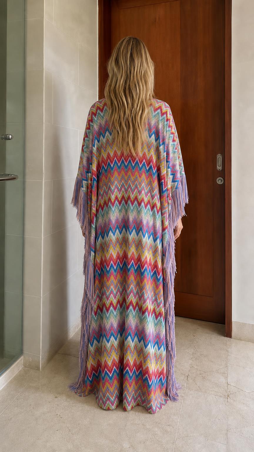 Back view of model in multi-colored chevron fringe maxi kaftan dress