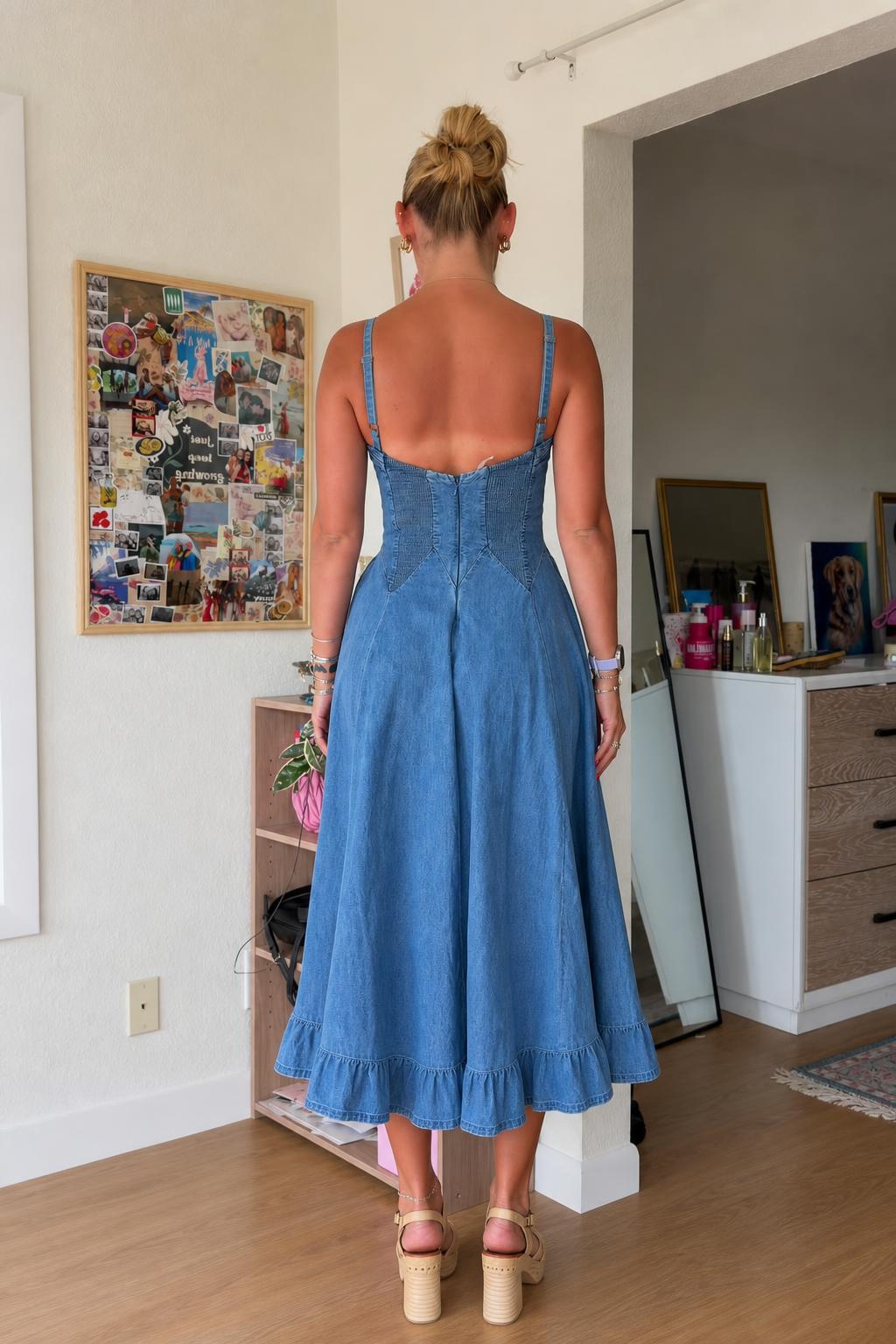 Back view of woman wearing blue denim midi dress