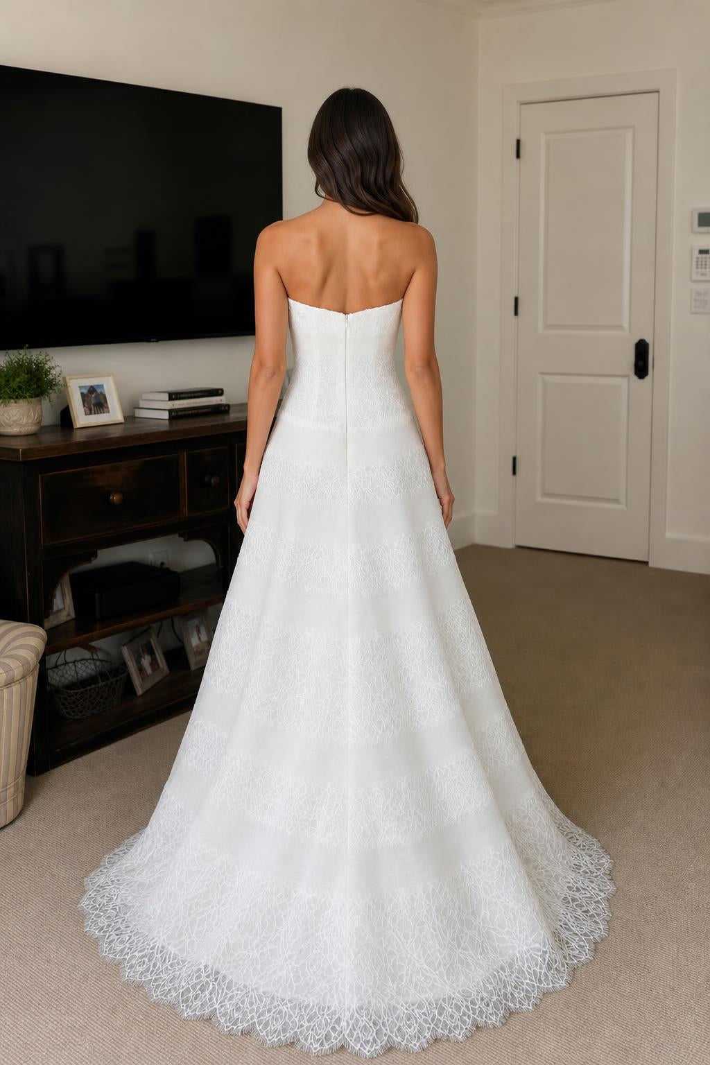 Back view of white strapless tiered lace evening dress
