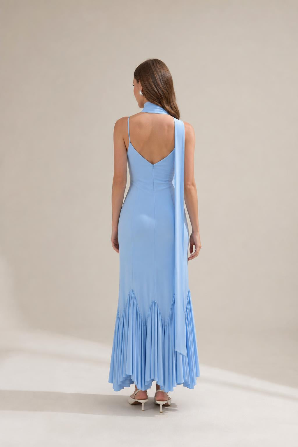 Back view of light blue maxi dress showing draping scarf
