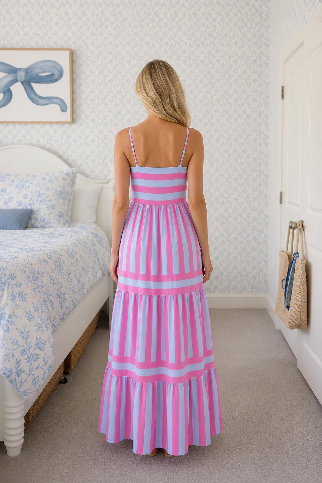 Back view of woman in pink and blue striped maxi dress