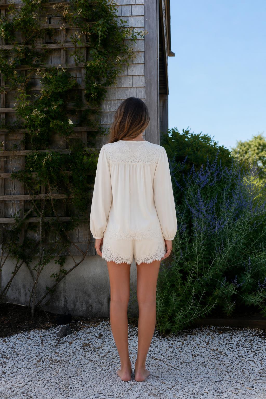 Back view of woman wearing cream lace trim lounge set
