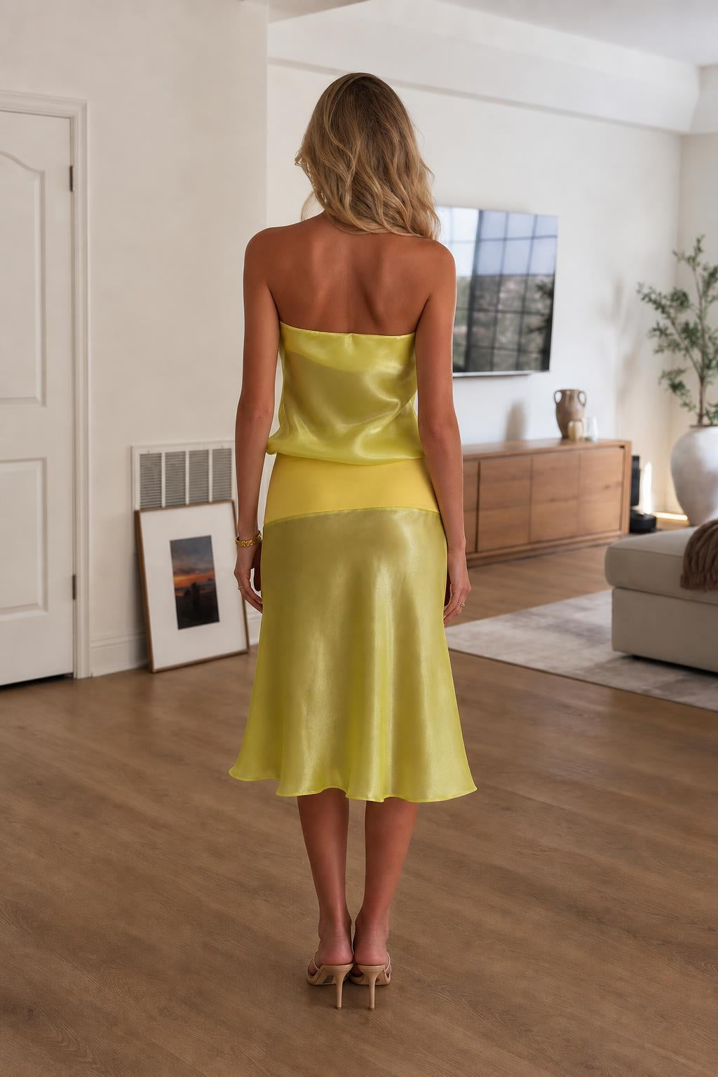 Back view of model in yellow satin two-piece set