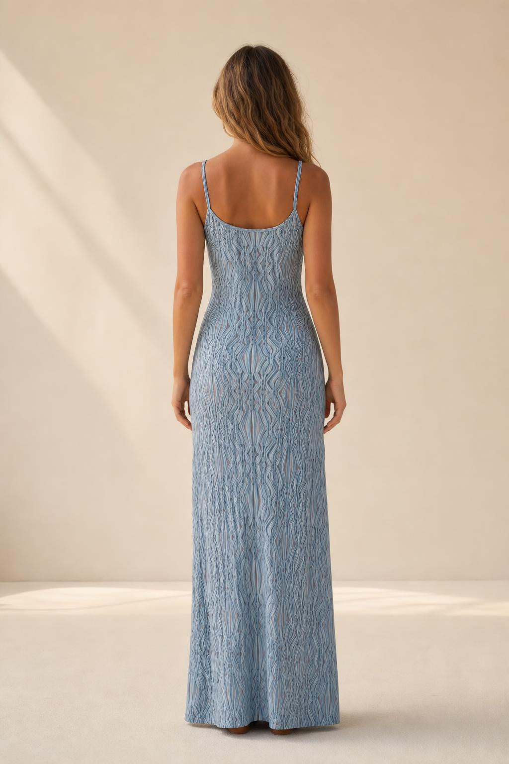 Back view of woman wearing blue sleeveless knit dress