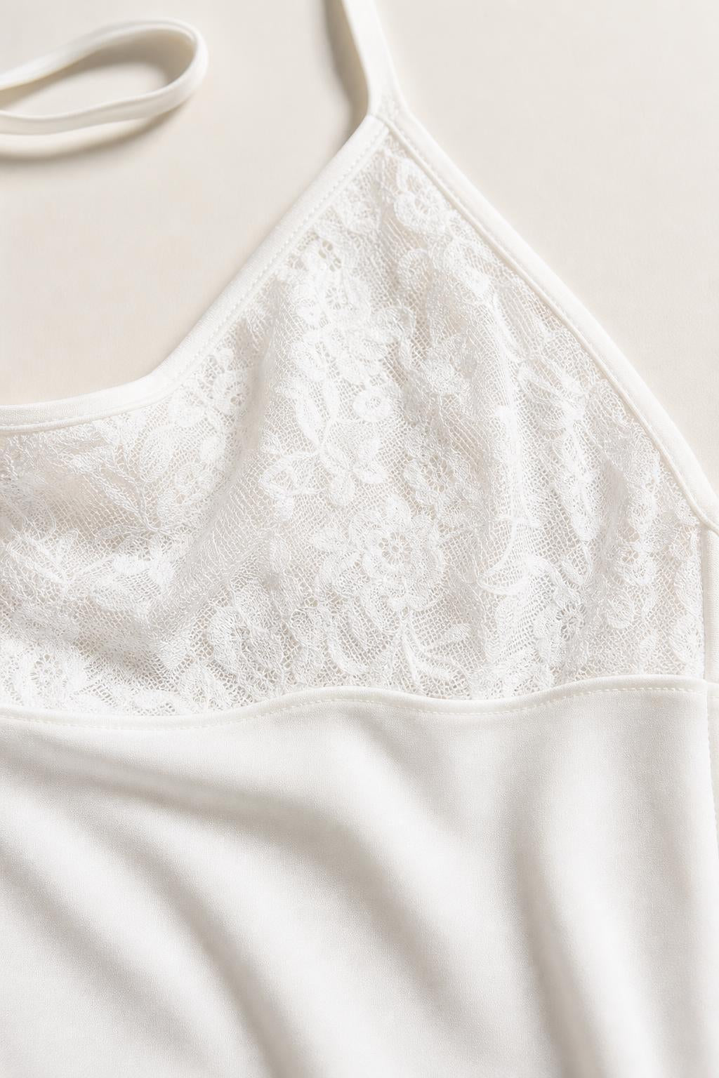 Close-up detail of white top lace trim and satin texture