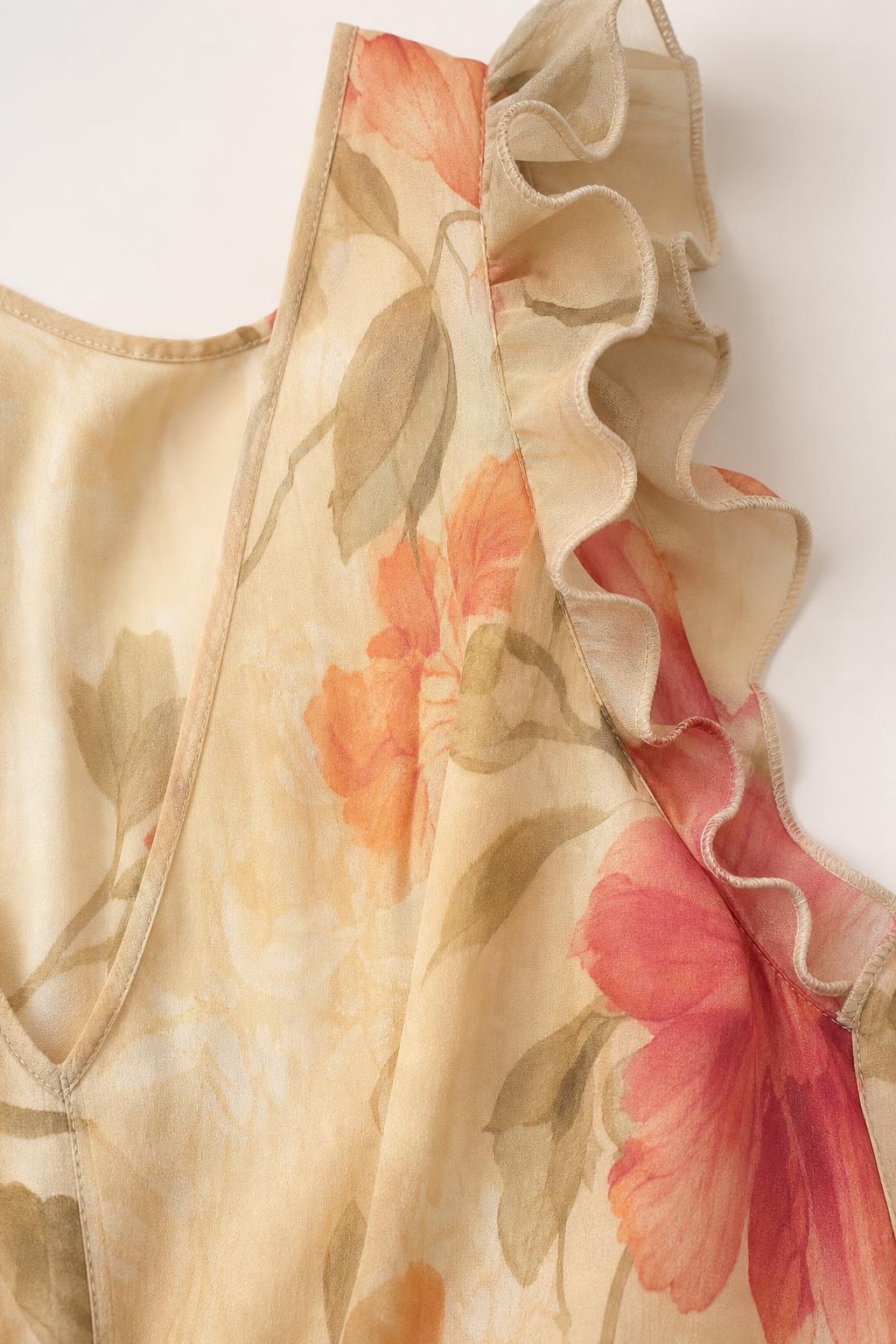 Close-up detail of ruffle strap and watercolor floral fabric