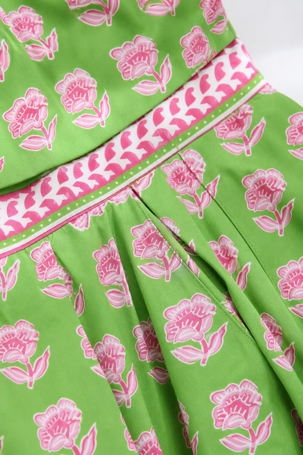 Close-up detail of green floral print and striped trim