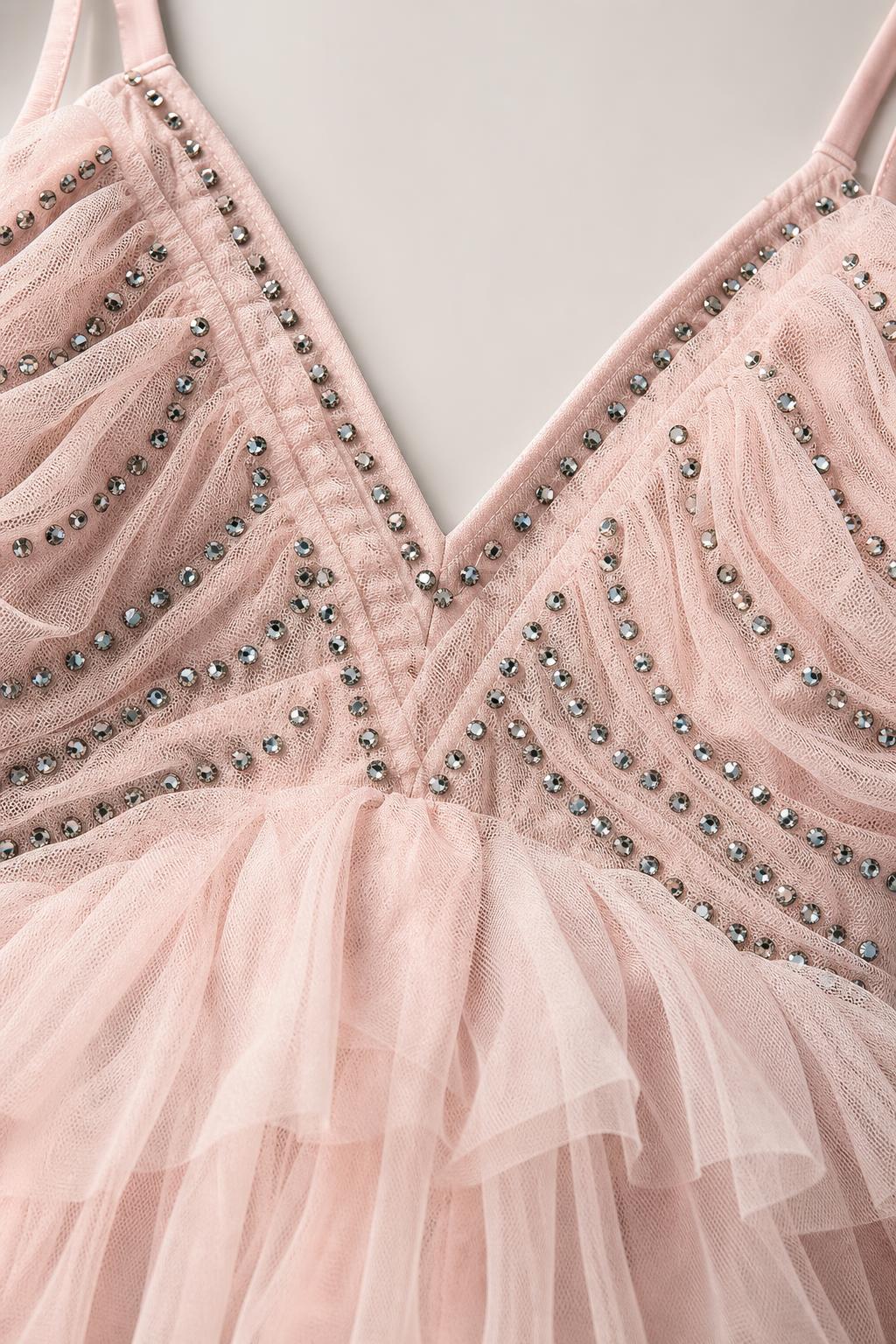 Close-up of V-neckline and bead embellishments on pink tulle dress