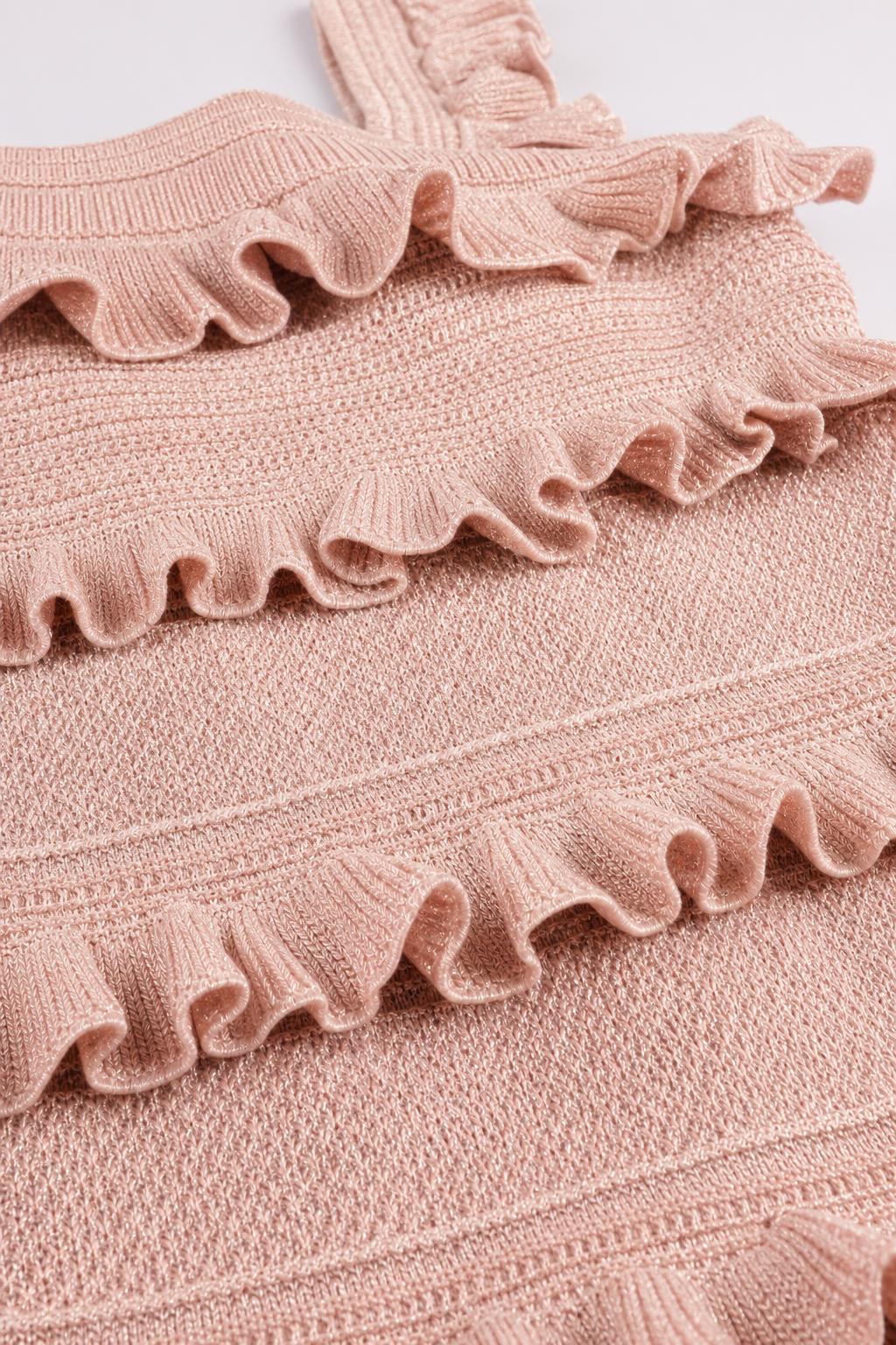 Close-up detail of textured knit fabric and ruffled tiers