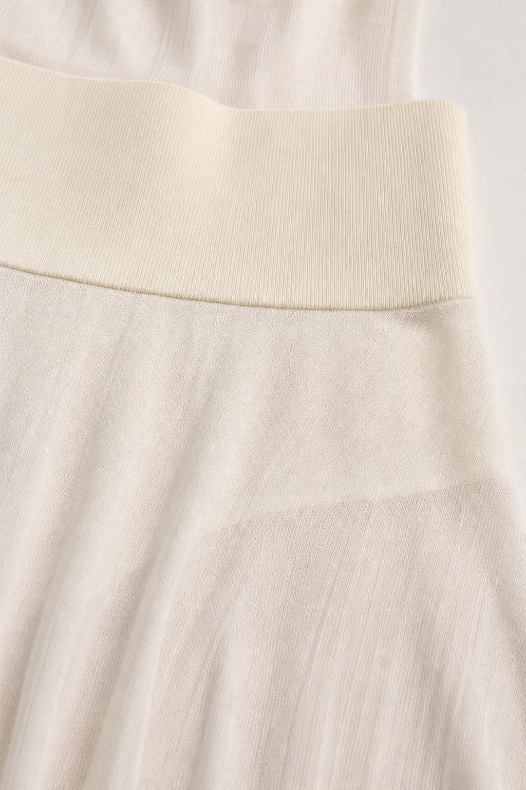 Close-up detail of the ribbed waistband on the knit dress