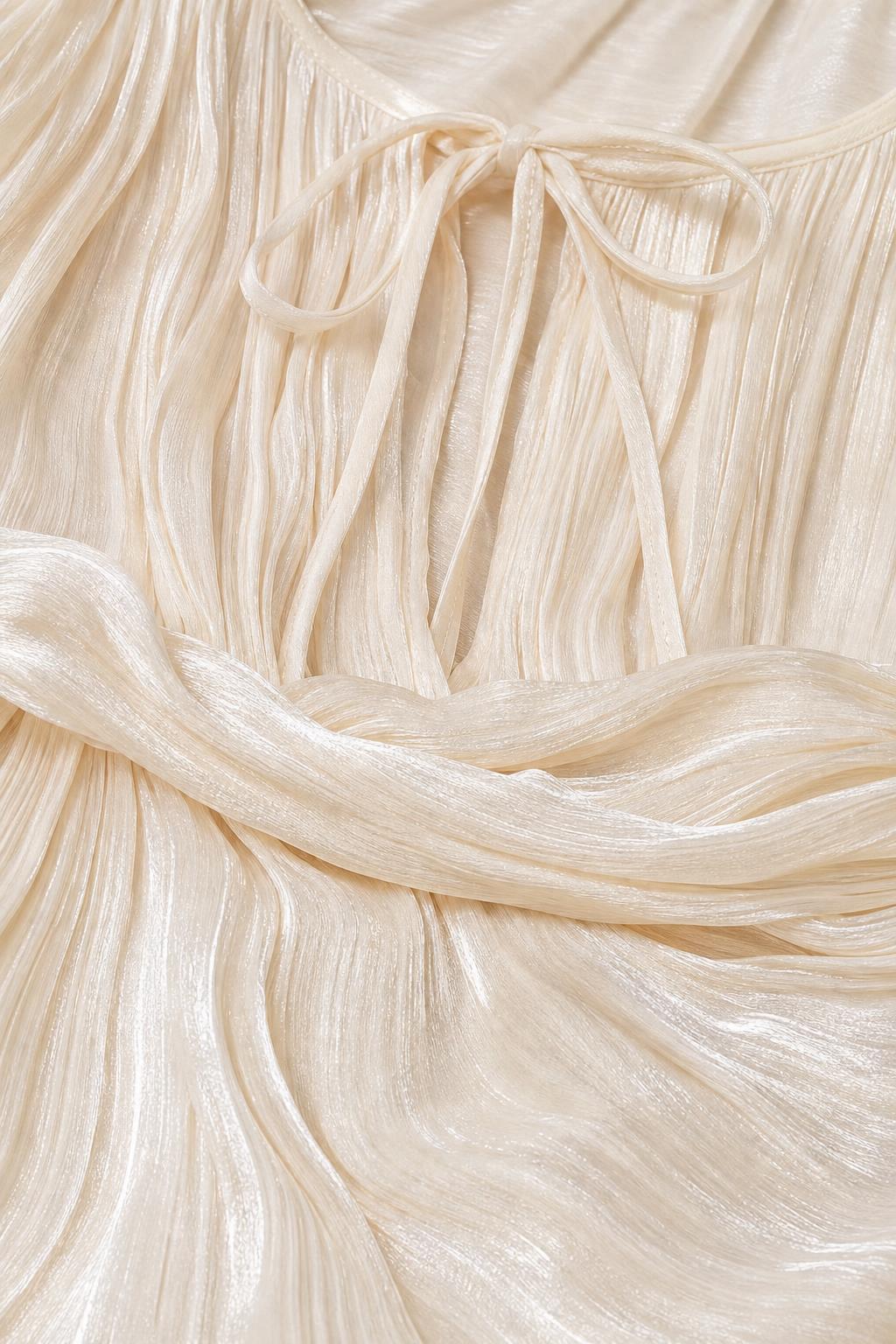 Close-up detail of fabric texture and tie neckline