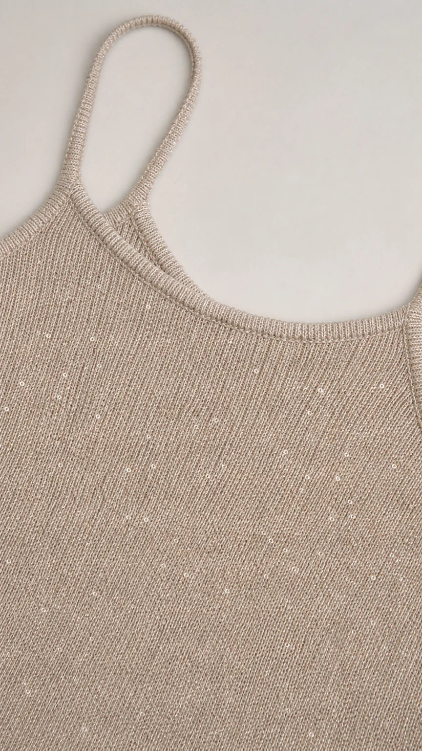 Close-up detail of the textured metallic champagne fabric and scoop neck