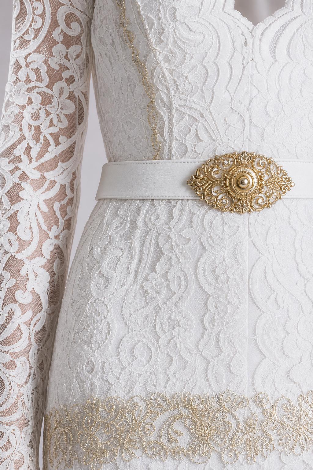 Close-up detail of white lace bodice and gold belt accent