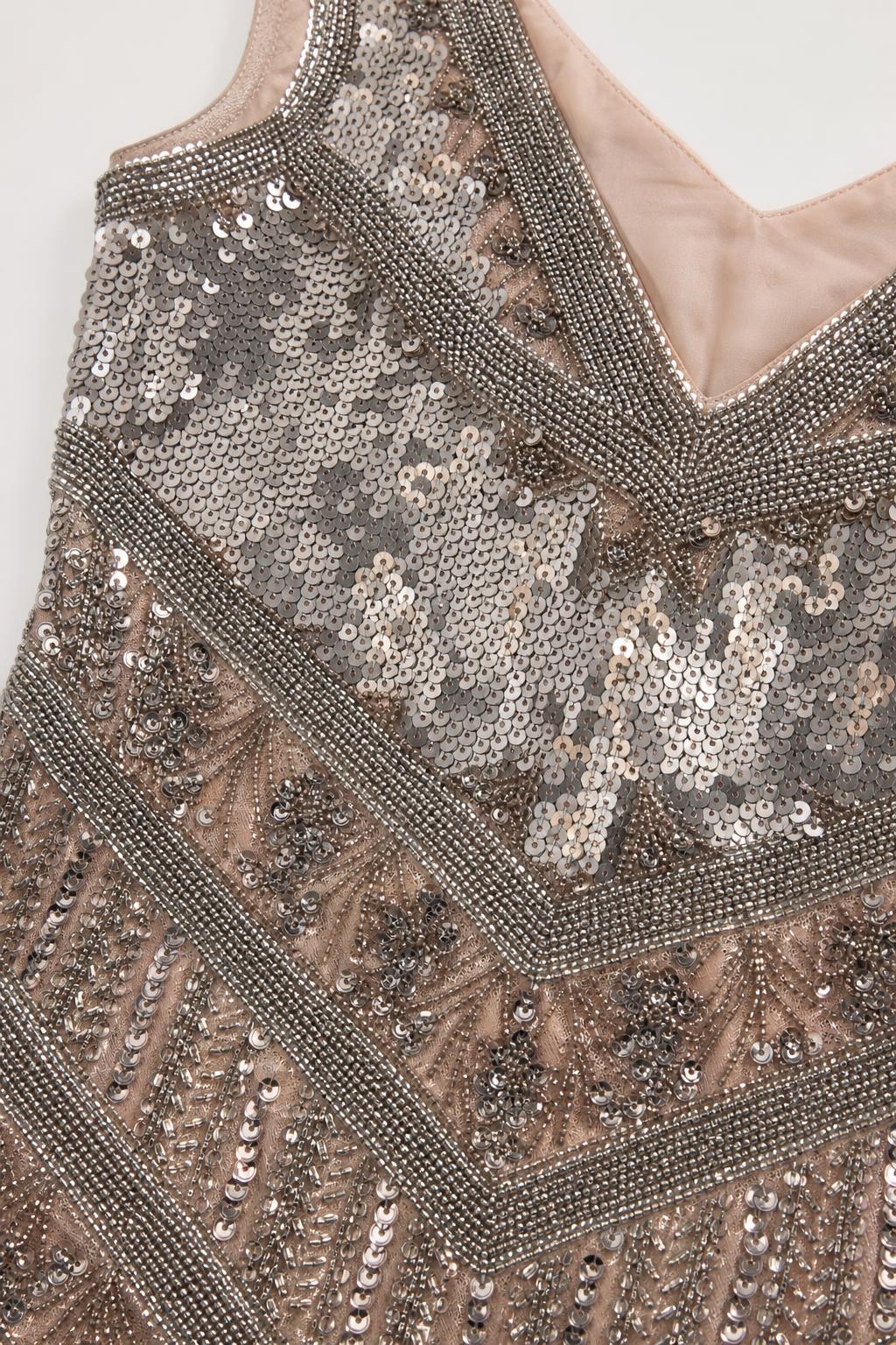 Close-up detail of the silver sequin and bead pattern